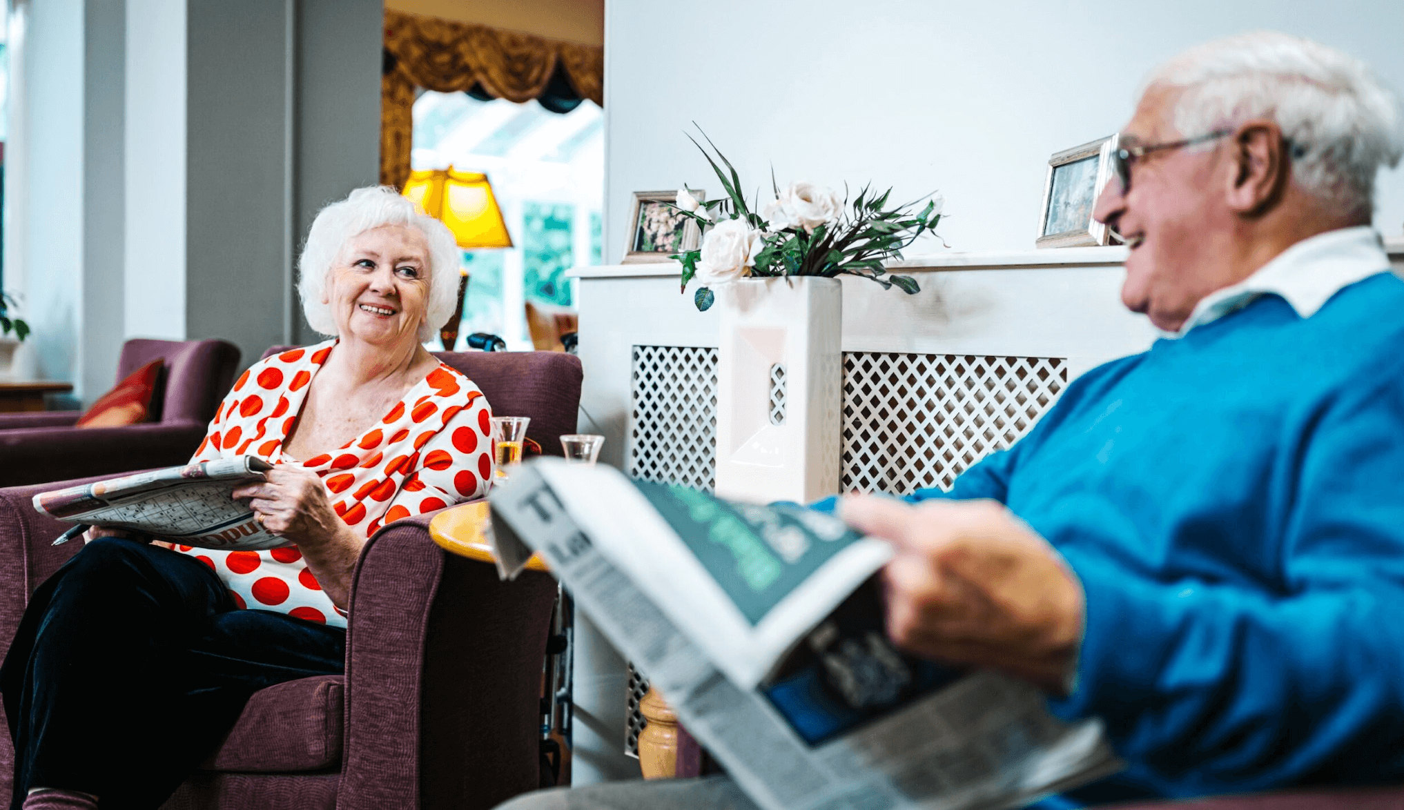 care home residents reading the newspaper
